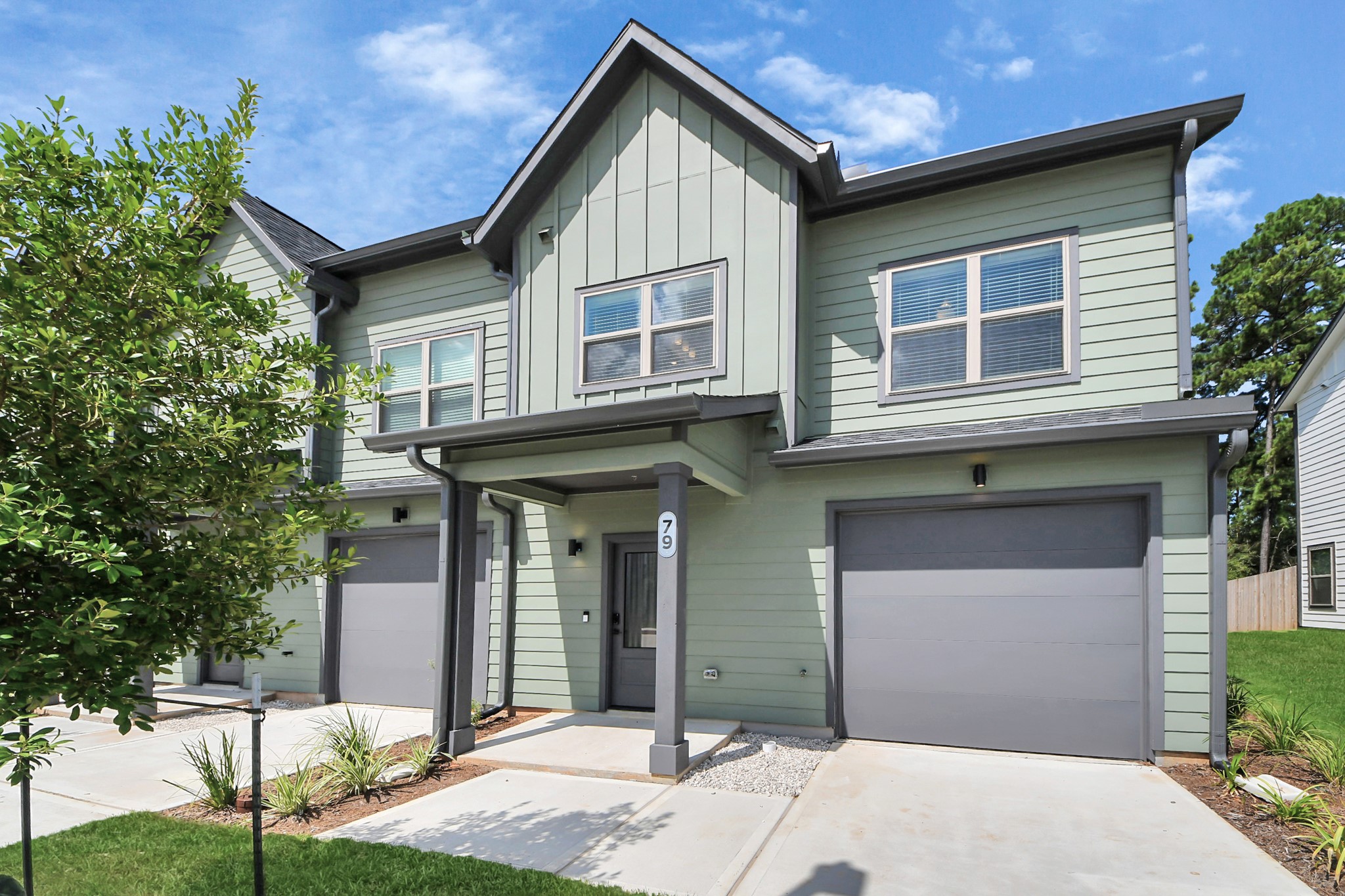 7711 Longmire Road, Unit 102 Conroe, TX 77304 - Photo 5 of 48 a front view of a house with garden