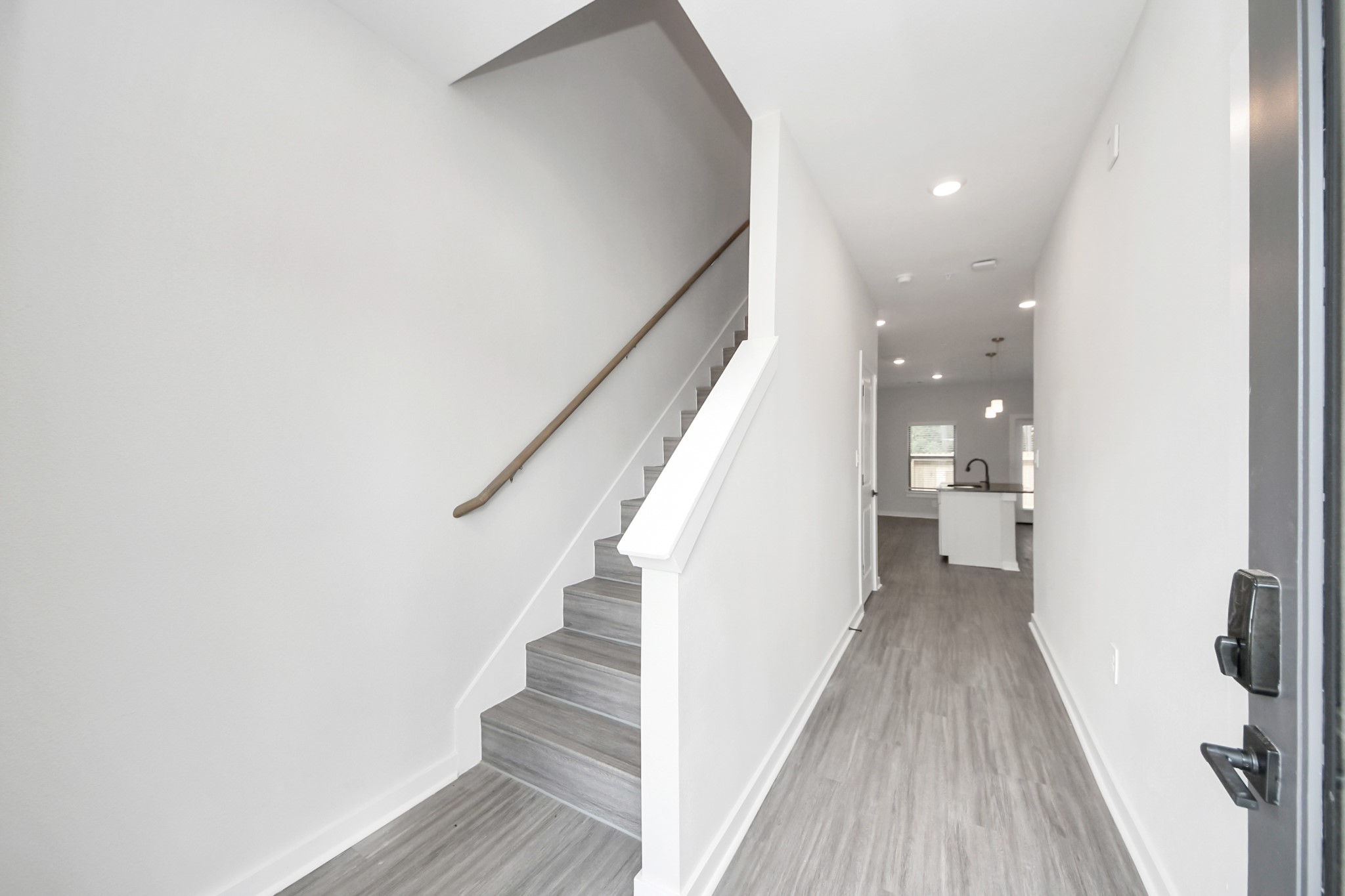 7711 Longmire Road, Unit 102 Conroe, TX 77304 - Photo 40 of 48 a view of a hallway with wooden floor and staircase