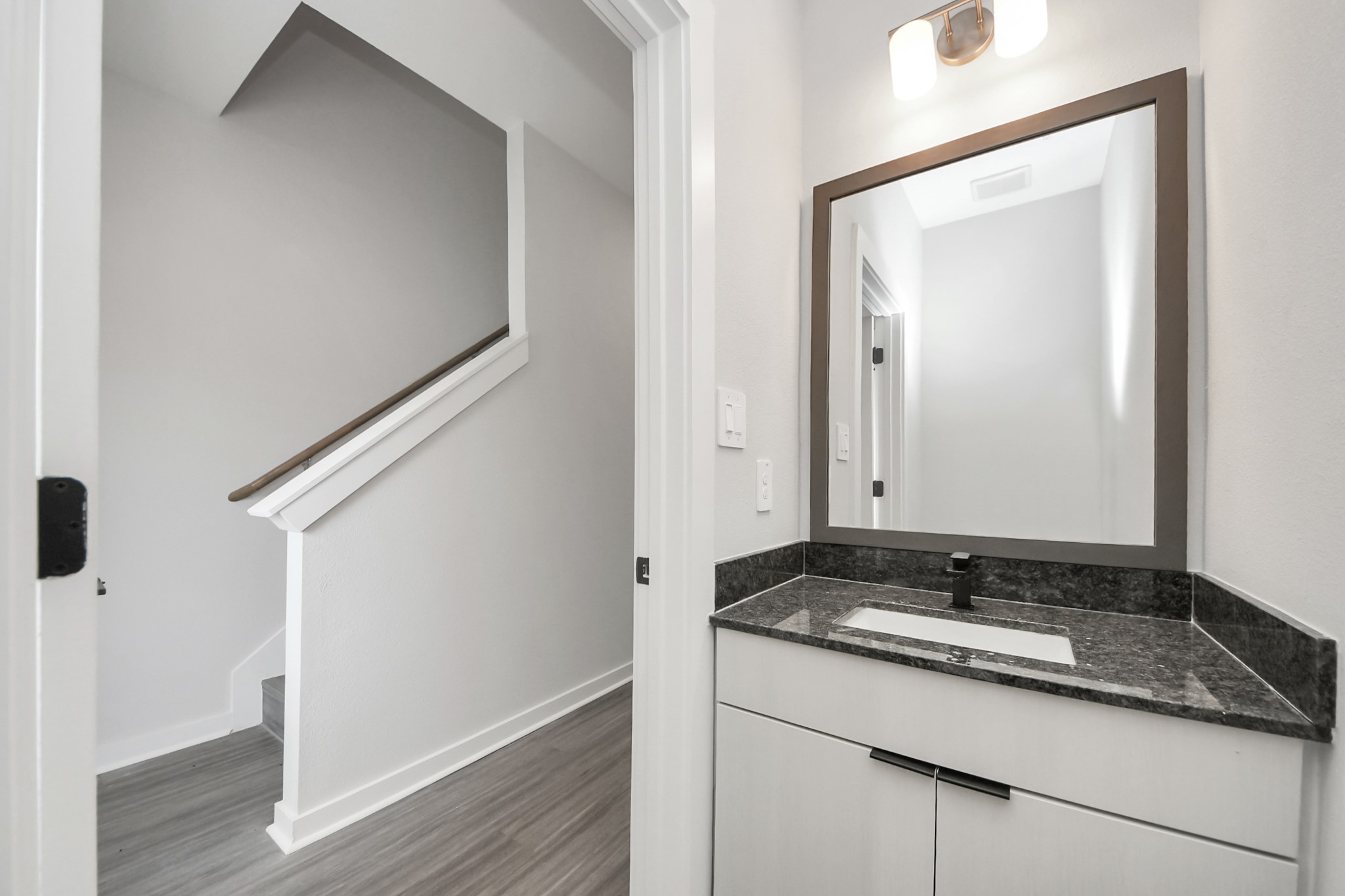 7711 Longmire Road, Unit 102 Conroe, TX 77304 - Photo 6 of 48 a bathroom with a granite countertop sink and a mirror