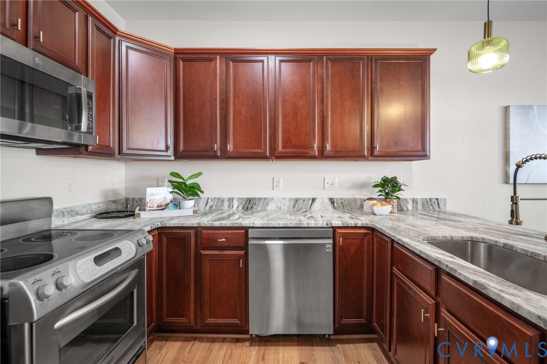 1024 Alcorn Terrace Midlothian, VA 23114 - Photo 14 of 50 a kitchen with stainless steel appliances granite countertop wooden cabinets a stove a sink and dishwasher
