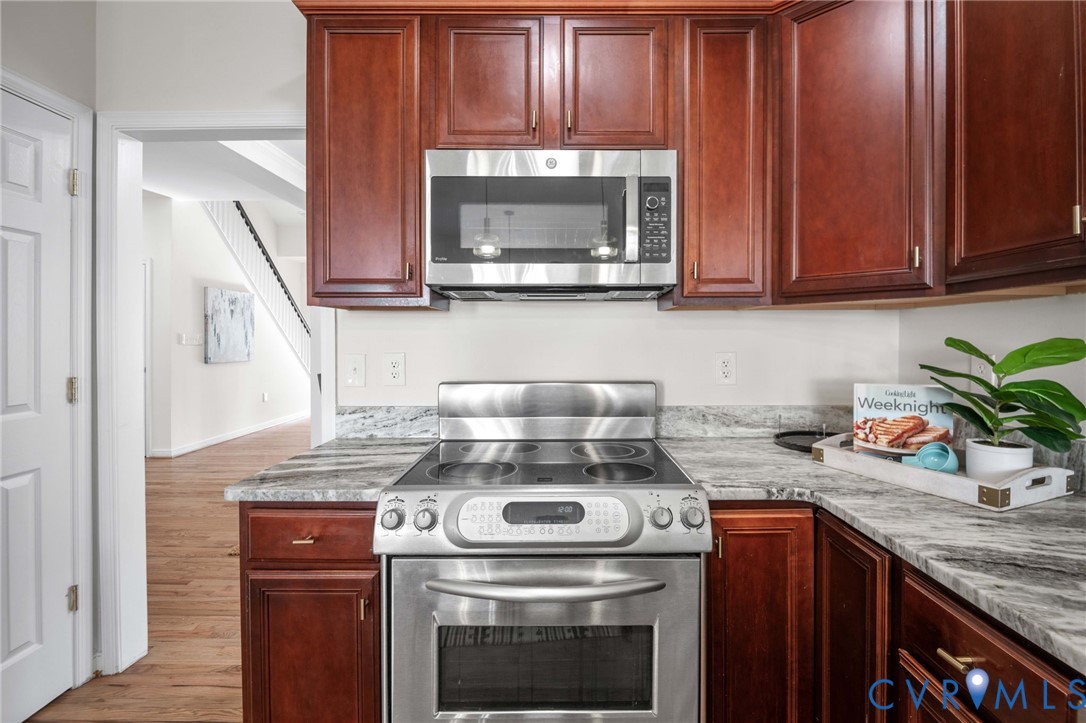1024 Alcorn Terrace Midlothian, VA 23114 - Photo 15 of 50 a kitchen with granite countertop a stove top oven microwave and cabinets