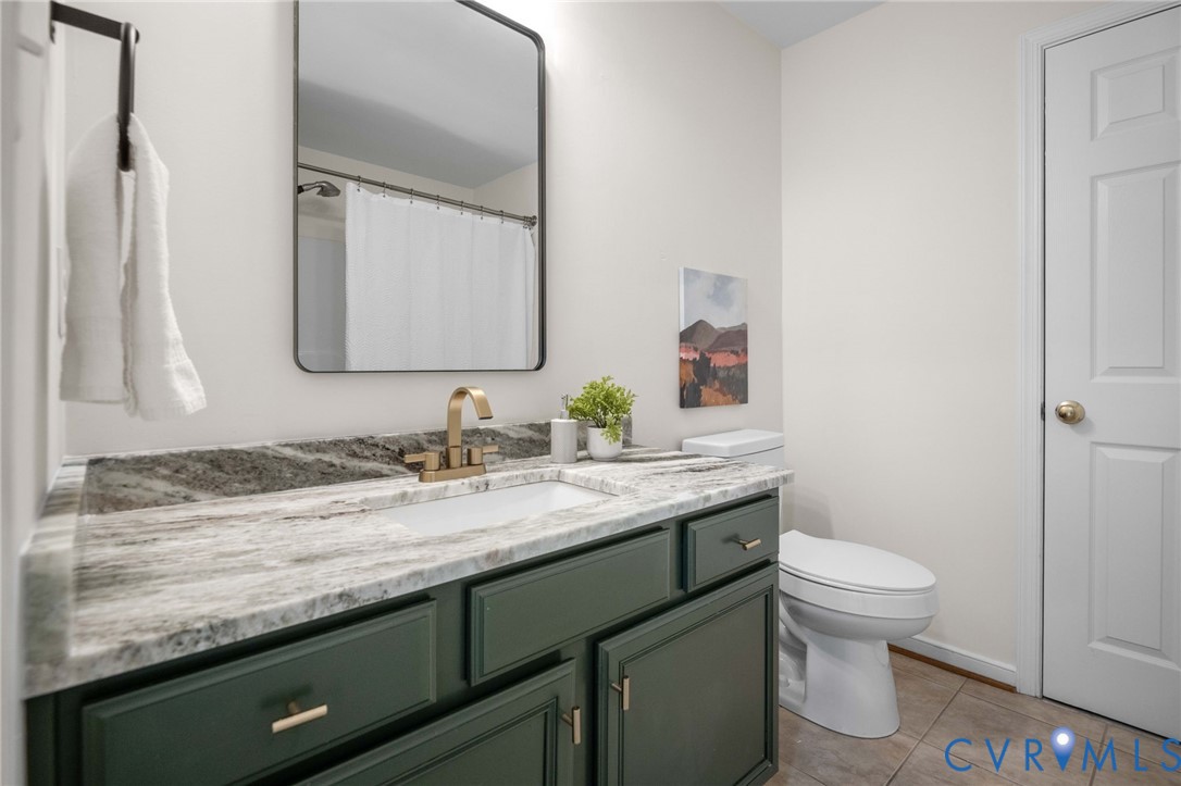 1024 Alcorn Terrace Midlothian, VA 23114 - Photo 37 of 50 a bathroom with a granite countertop sink a toilet and a mirror