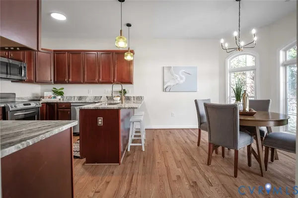 a view of a dining room with furniture and wooden floor