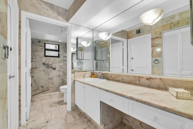 a bathroom with a sink toilet and shower