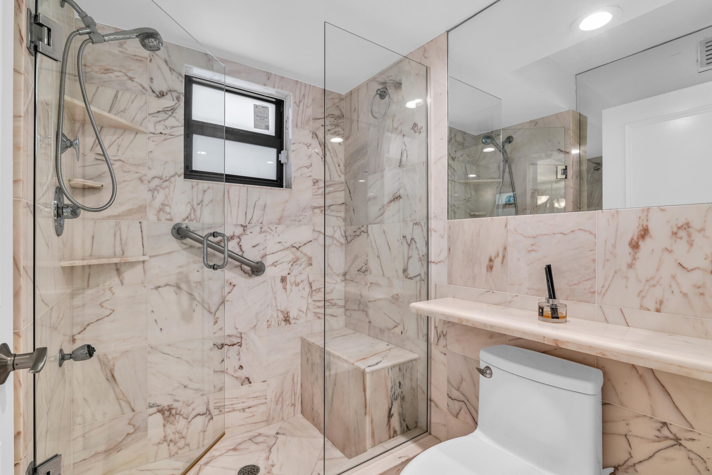 277 North Ocean Boulevard, Unit 1010 Boca Raton, FL 33432 - Photo 17 of 30 a bathroom with a sink toilet and shower