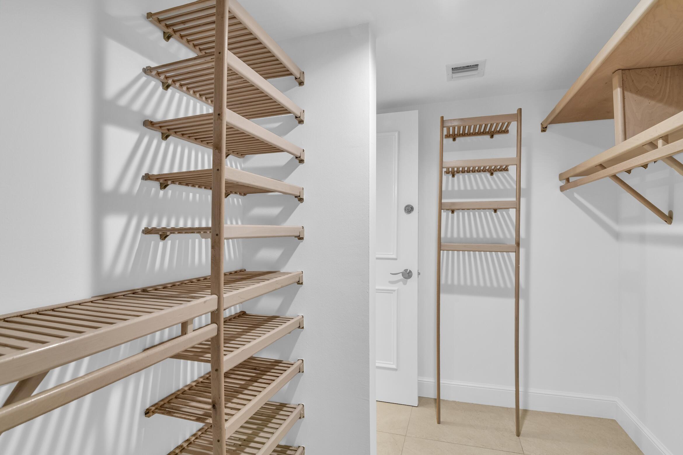 277 North Ocean Boulevard, Unit 1010 Boca Raton, FL 33432 - Photo 18 of 30 a room with walk in closet and empty racks