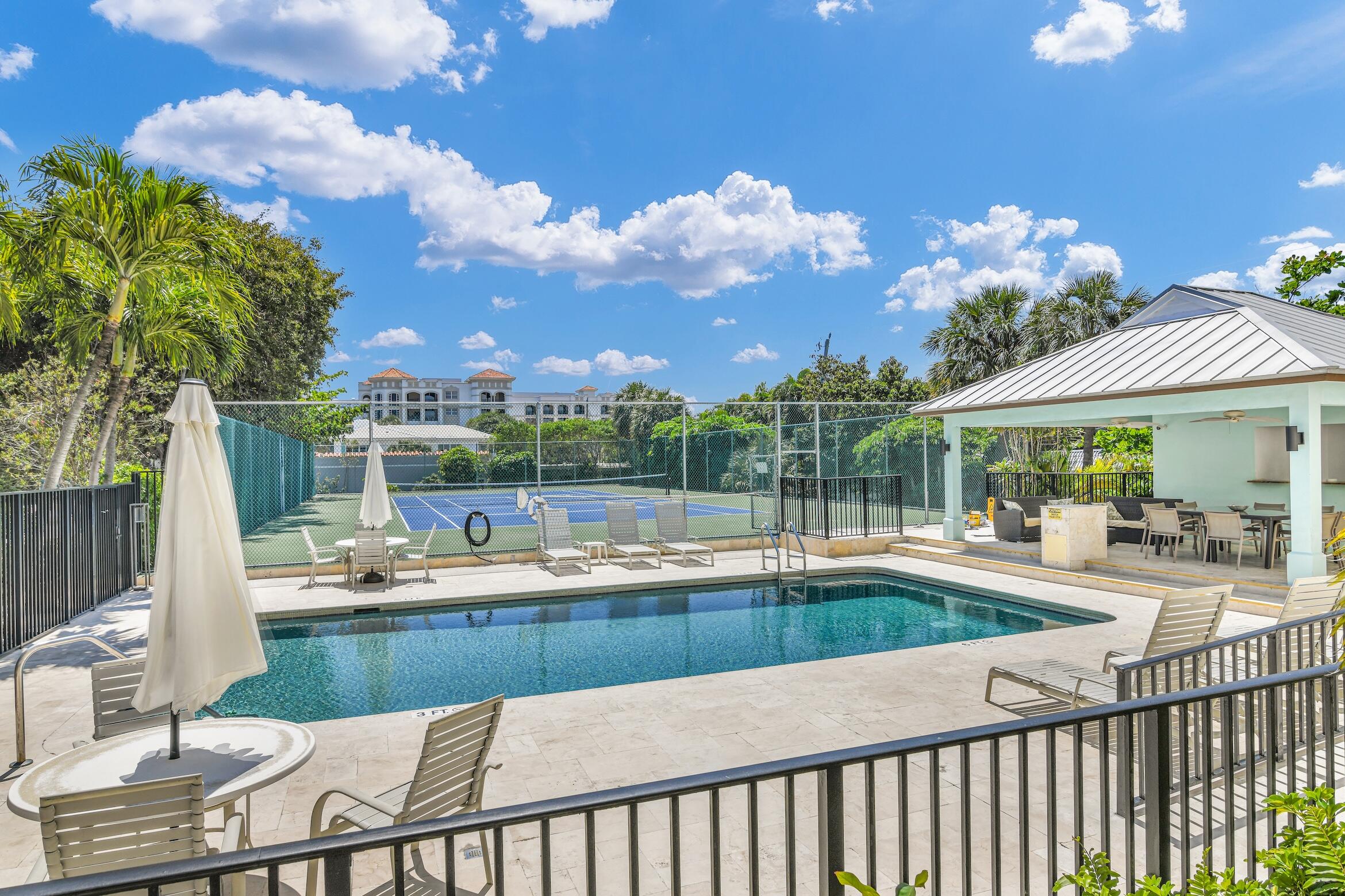 277 North Ocean Boulevard, Unit 1010 Boca Raton, FL 33432 - Photo 19 of 30 a view of a swimming pool with a patio