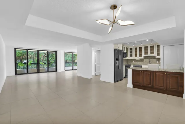 a view of kitchen with stainless steel appliances granite countertop a stove top oven a sink with dishwasher and cabinets