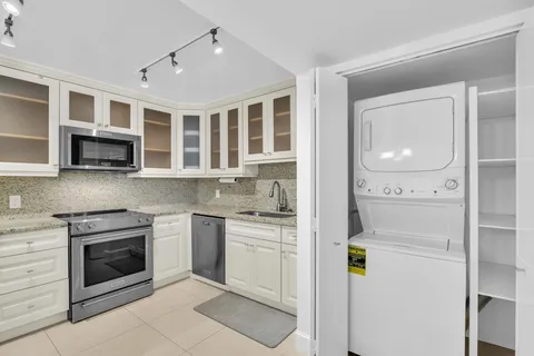 a kitchen with stainless steel appliances granite countertop a stove and a sink