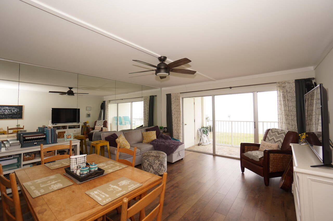 151 Calhoun Avenue, Unit 201 Destin, FL 32541 - Photo 11 of 55 a living room with furniture a flat screen tv and a large window