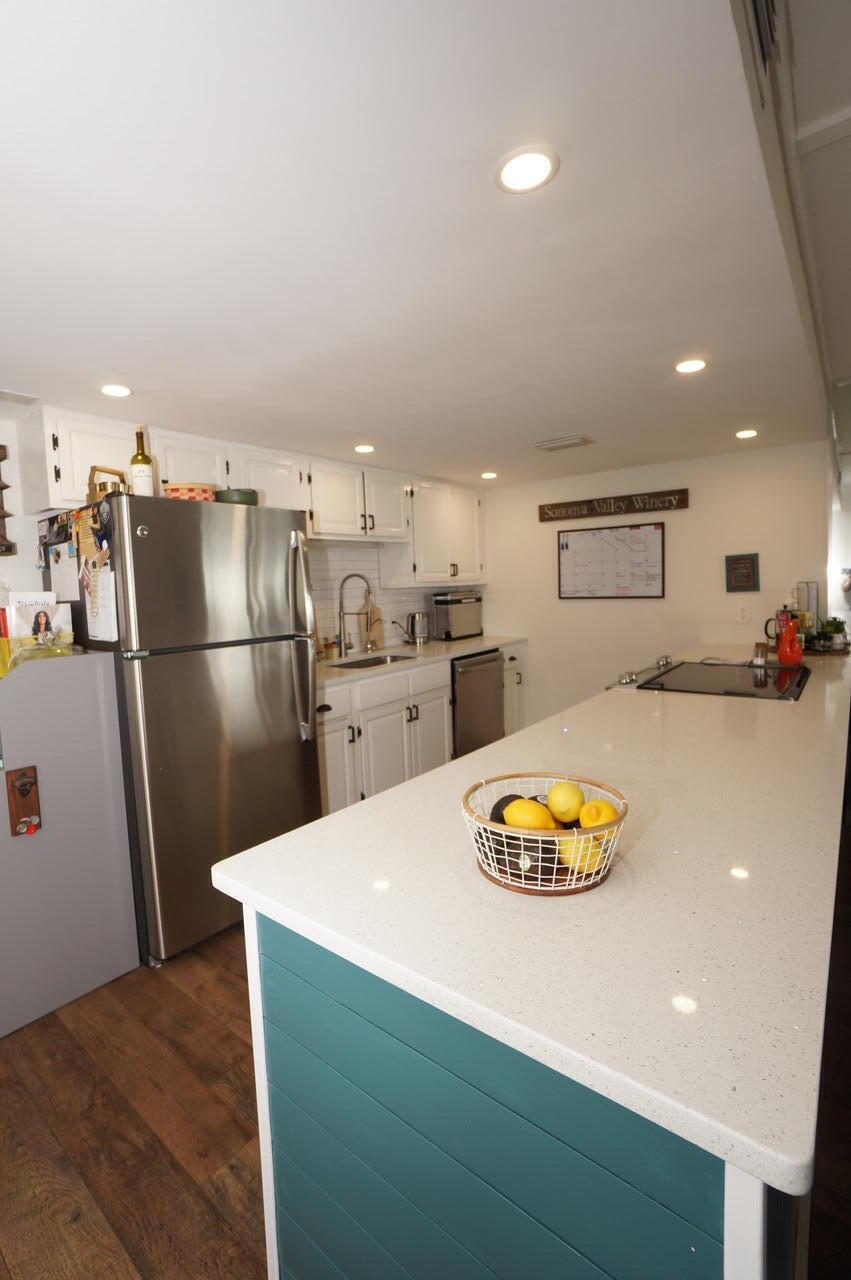 151 Calhoun Avenue, Unit 201 Destin, FL 32541 - Photo 19 of 55 a kitchen with stainless steel appliances a refrigerator and a sink