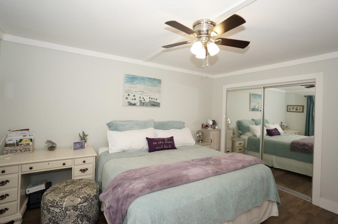 151 Calhoun Avenue, Unit 201 Destin, FL 32541 - Photo 23 of 55 a bedroom with a bed and ceiling fan