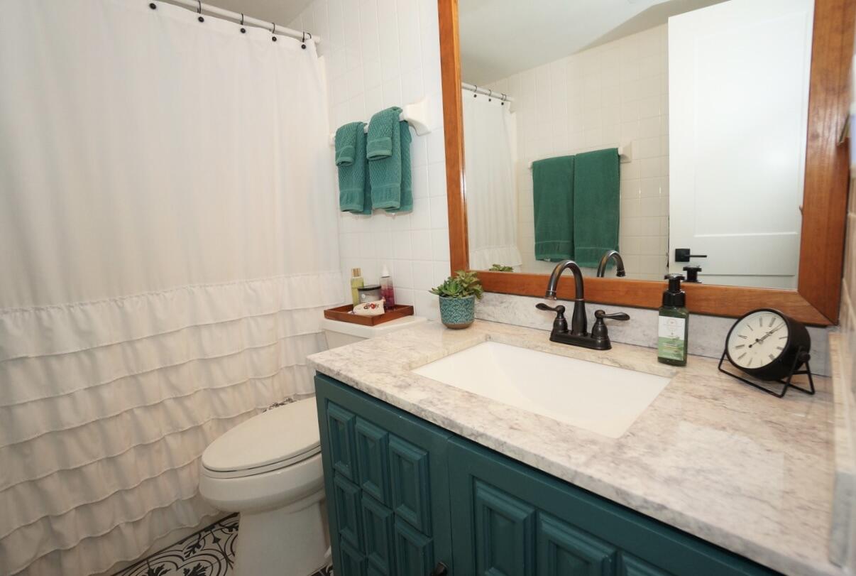 151 Calhoun Avenue, Unit 201 Destin, FL 32541 - Photo 25 of 55 a bathroom with a granite countertop sink and a mirror