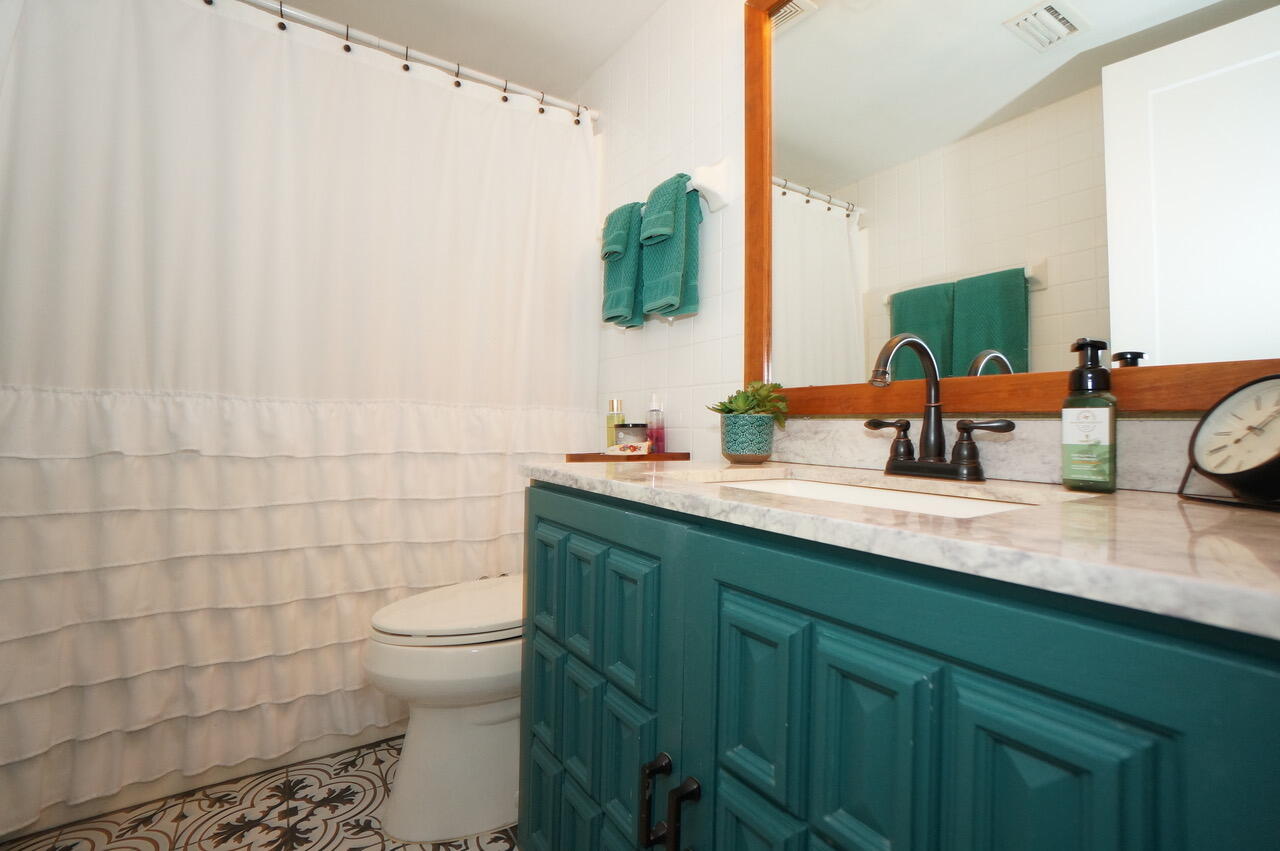 151 Calhoun Avenue, Unit 201 Destin, FL 32541 - Photo 26 of 55 a bathroom with a double vanity sink toilet and mirror