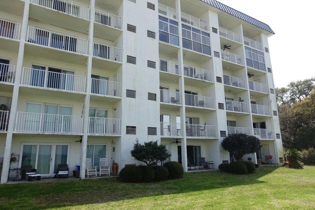151 Calhoun Avenue, Unit 201 Destin, FL 32541 - Photo 44 of 55 a front view of a building with a yard