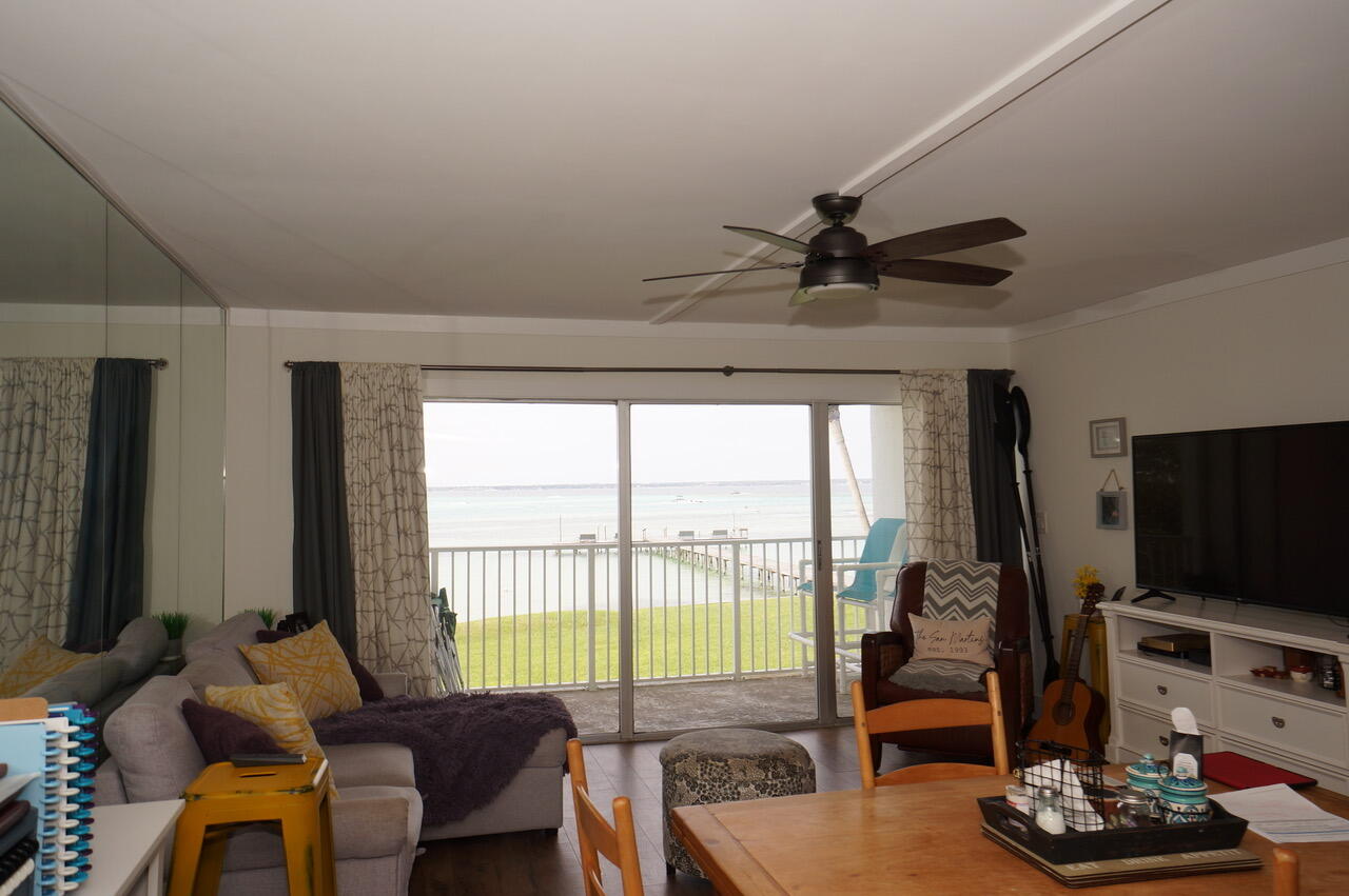 151 Calhoun Avenue, Unit 201 Destin, FL 32541 - Photo 8 of 55 a living room with furniture a flat screen tv and a large window