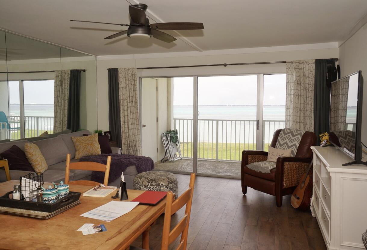 151 Calhoun Avenue, Unit 201 Destin, FL 32541 - Photo 9 of 55 a living room with furniture and a flat screen tv