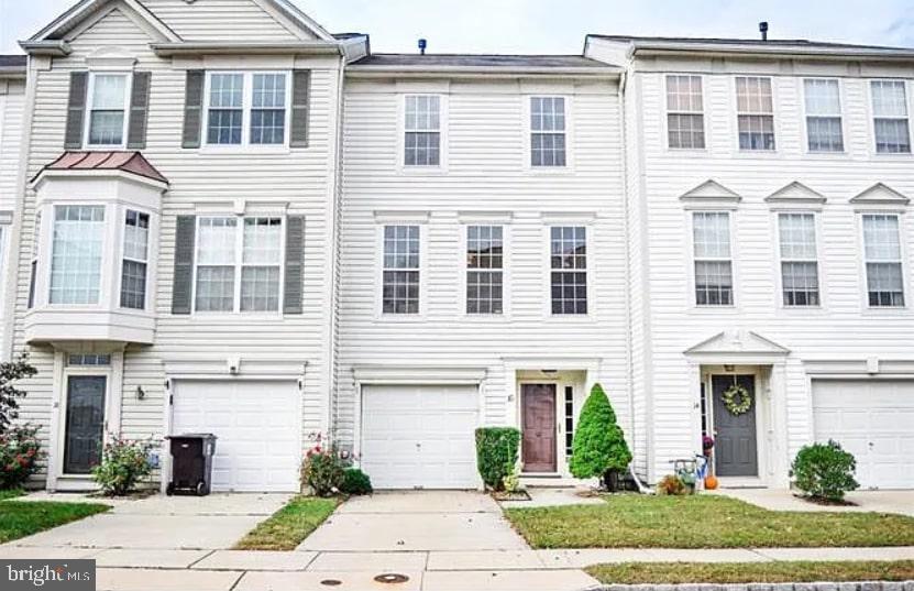 a front view of a building with a garden and plants