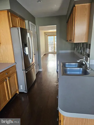 a view of a refrigerator a sink and dishwasher in a kitchen