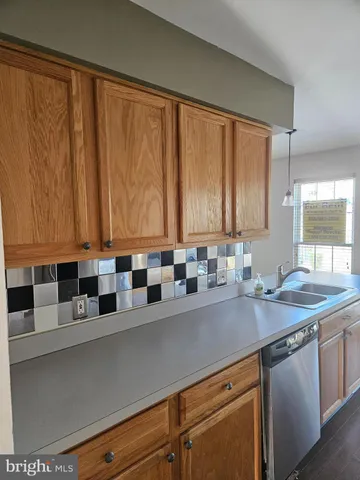 a kitchen with a sink and a window