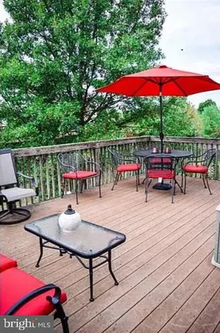 an outdoor sitting area with furniture and umbrella