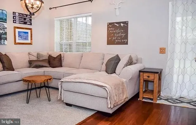 a bedroom with a bed and a couch next to a window