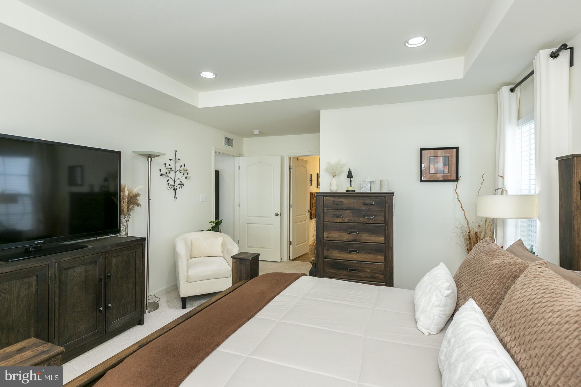 51 Ludgate Manor Falling Waters, WV 25419 - Photo 28 of 59 Primary bedroom with modern elegance.