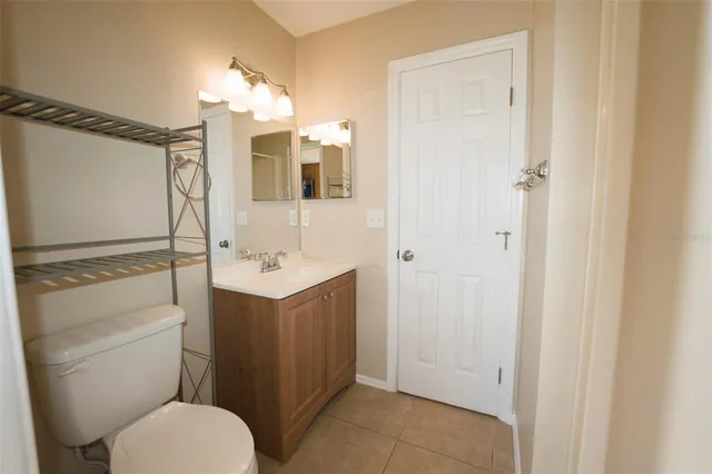 a bathroom with a sink a toilet a mirror and shower