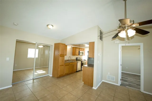 a view of a kitchen with refrigerator and sink