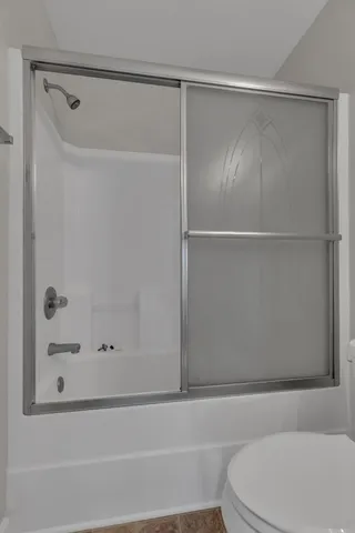 a bathroom with a shower and a toilet