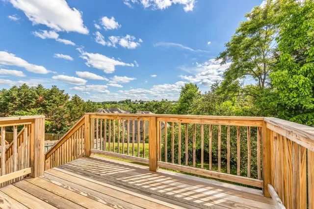 a balcony with wooden floor and fence