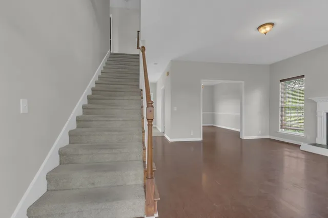 a view of an entryway with wooden floor and stairs