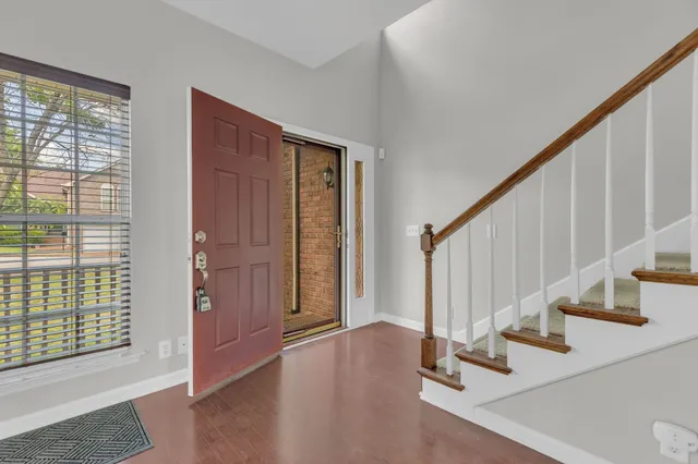 a view of an entryway with wooden floor and door