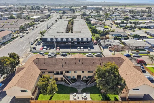 an aerial view of a large building with an outdoor space and seating area