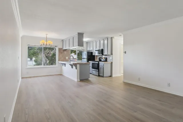 a kitchen with stainless steel appliances a stove top oven and a refrigerator