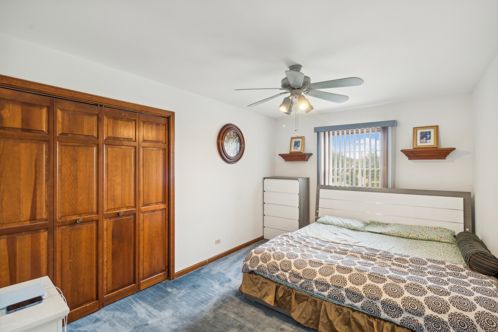 1605 Charlemagne Drive Hoffman Estates, IL 60192 - Photo 18 of 29 a bedroom with a large bed and a chandelier