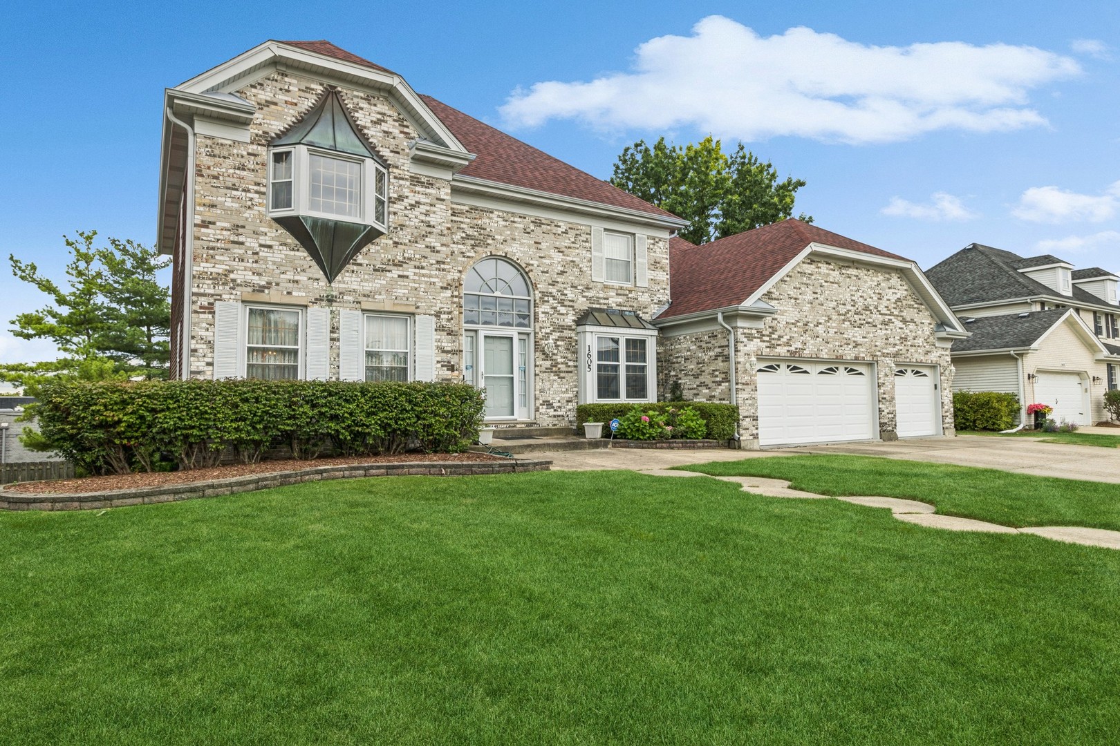 1605 Charlemagne Drive Hoffman Estates, IL 60192 - Photo 3 of 29 a front view of a house with a garden