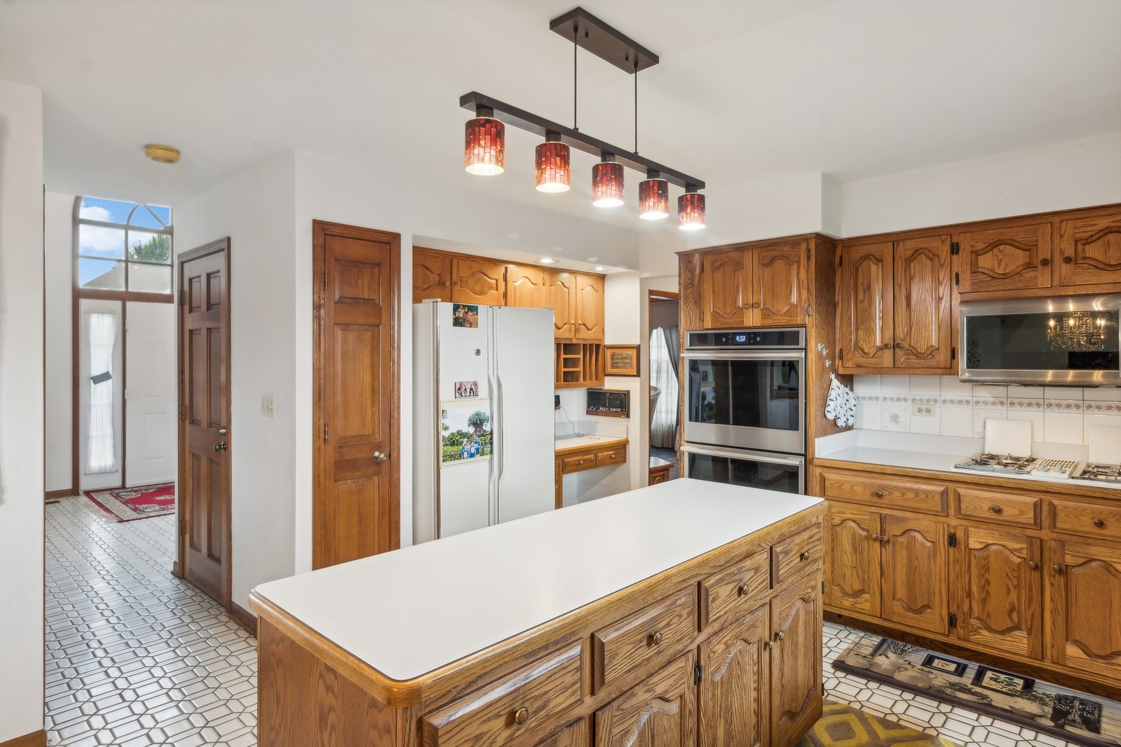 1605 Charlemagne Drive Hoffman Estates, IL 60192 - Photo 9 of 29 a kitchen with stainless steel appliances kitchen island granite countertop a refrigerator and a stove top oven