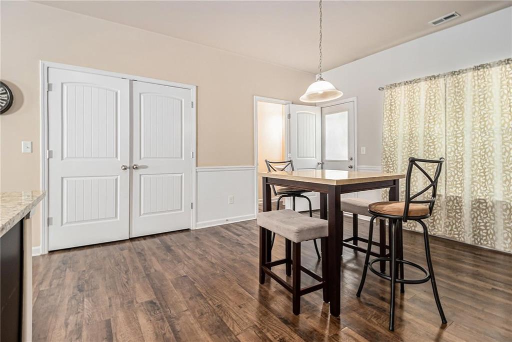 6148 Oakley Road, Unit 23 Union City, GA 30291 - Photo 13 of 26 a dining room that has a table chairs and a wooden floor