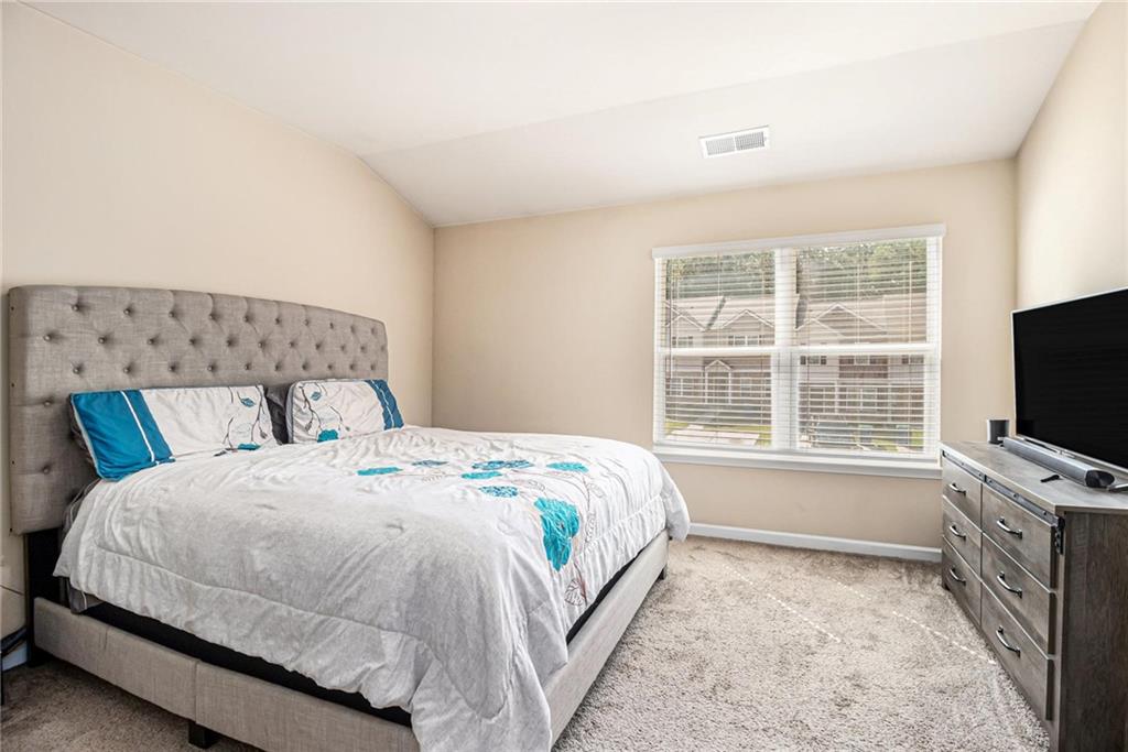 6148 Oakley Road, Unit 23 Union City, GA 30291 - Photo 16 of 26 a bedroom with a bed and a flat screen tv