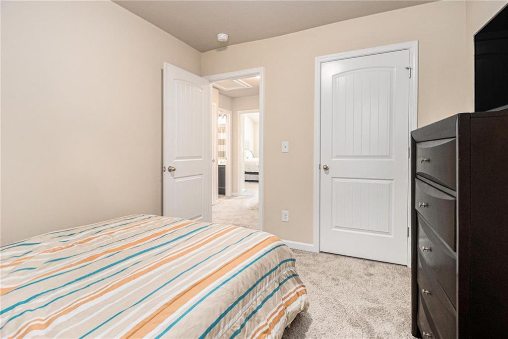 6148 Oakley Road, Unit 23 Union City, GA 30291 - Photo 20 of 26 a bedroom with a bed and a refrigerator