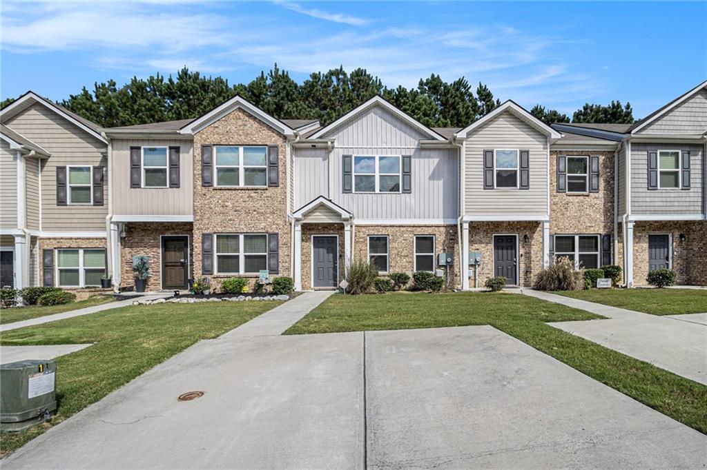 6148 Oakley Road, Unit 23 Union City, GA 30291 - Photo 3 of 26 a view of a white house with a yard and potted plants