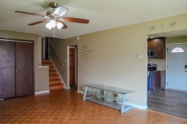 a view of livingroom with hardwood floor and ceiling fan
