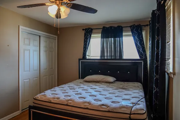 a bedroom with a bed and a chandelier