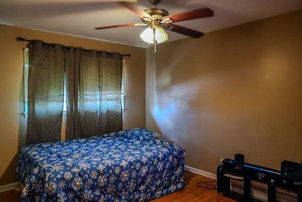 a bedroom with a bed and a chandelier