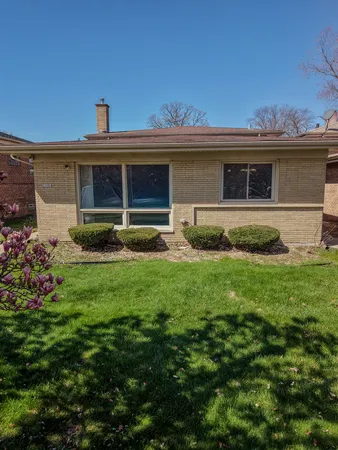 a view of a house with a yard and sitting area