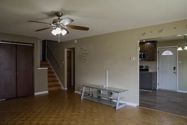 a view of a livingroom with furniture and staircase