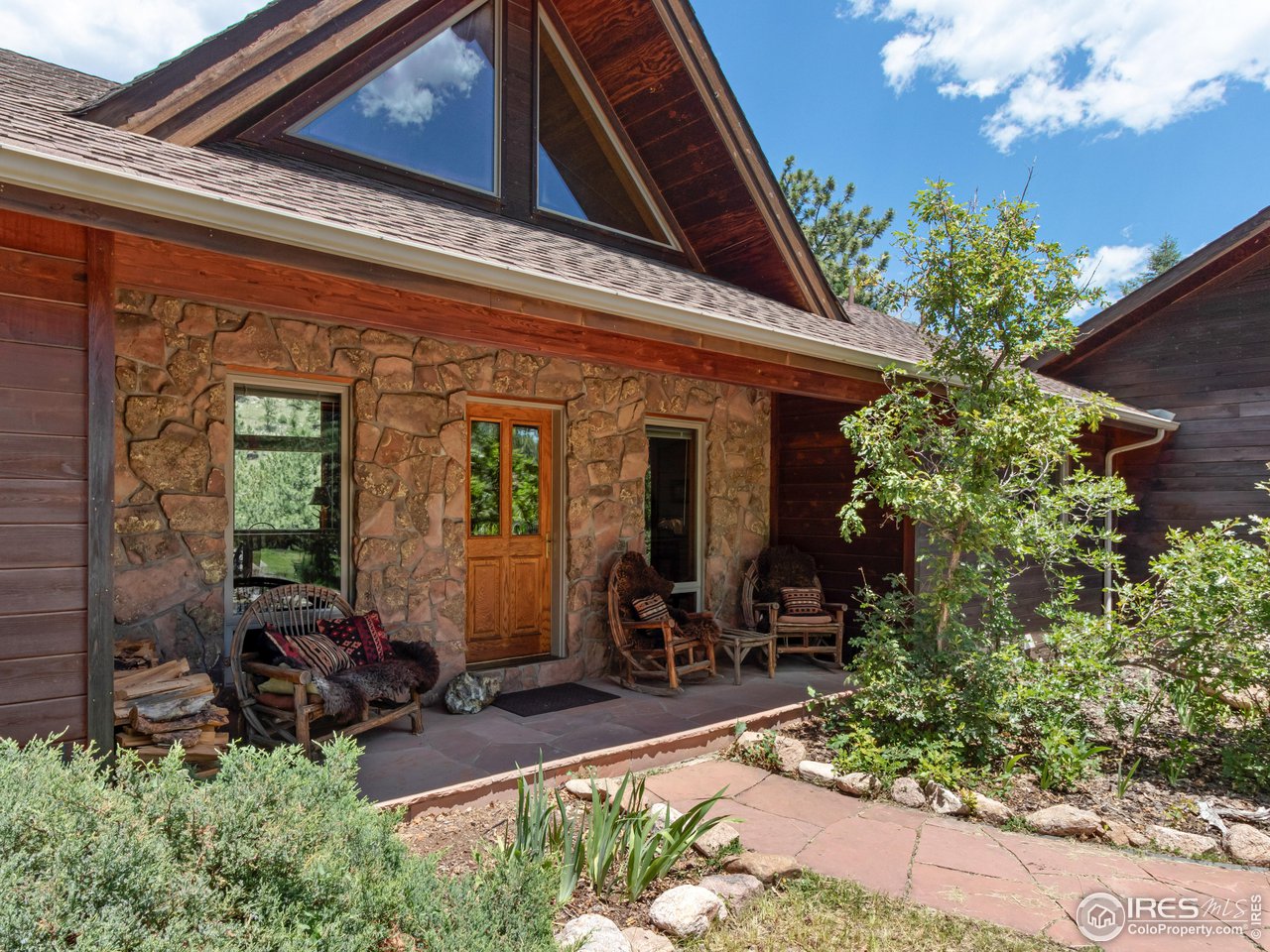 287 Wichita Road Lyons, CO 80540 - Photo 11 of 40 a view of house with yard outdoor seating and covered with potted plants