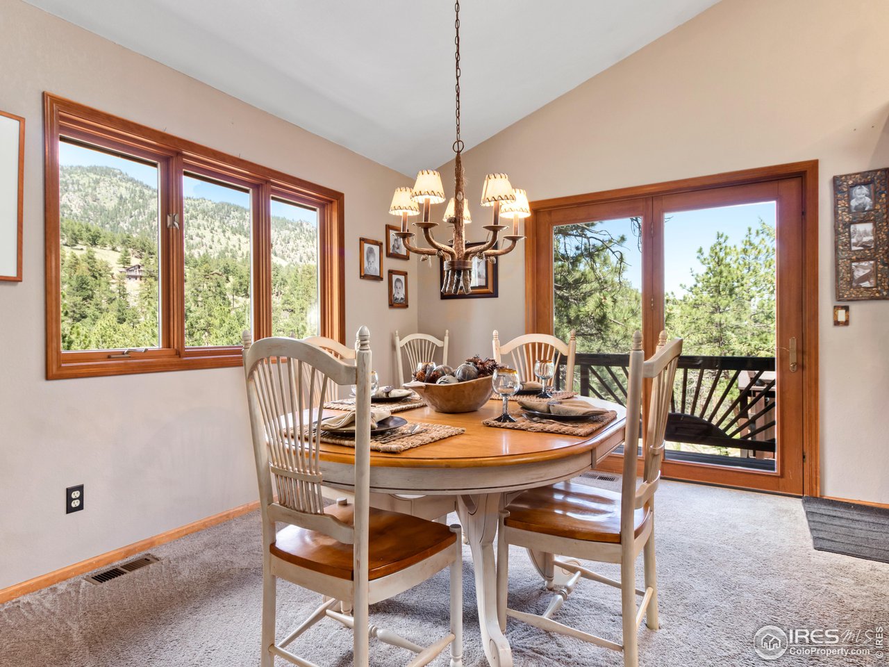 287 Wichita Road Lyons, CO 80540 - Photo 15 of 40 a view of a dining room with furniture a chandelier and wooden floor