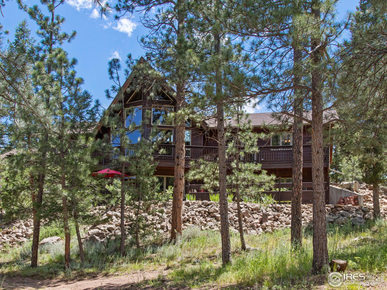 287 Wichita Road Lyons, CO 80540 - Photo 18 of 40 a view of a house with a tree